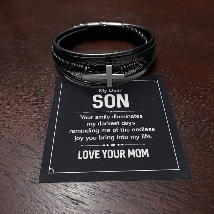 To My Dear Son | Your smile illuminates' my darkest shades - Men's Cross Leather Bracelet