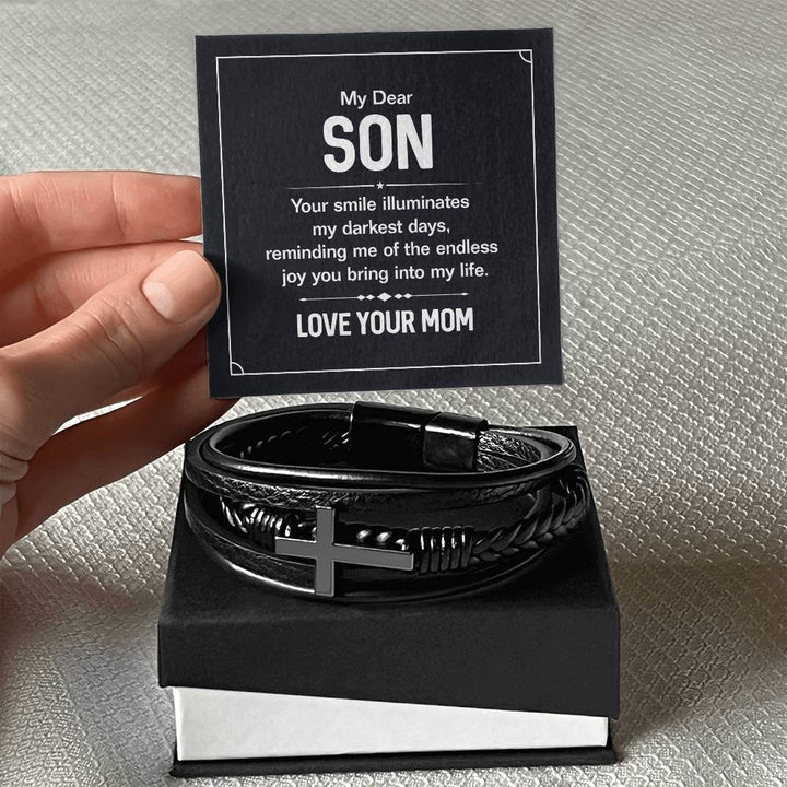 To My Dear Son | Your smile illuminates' my darkest shades - Men's Cross Leather Bracelet