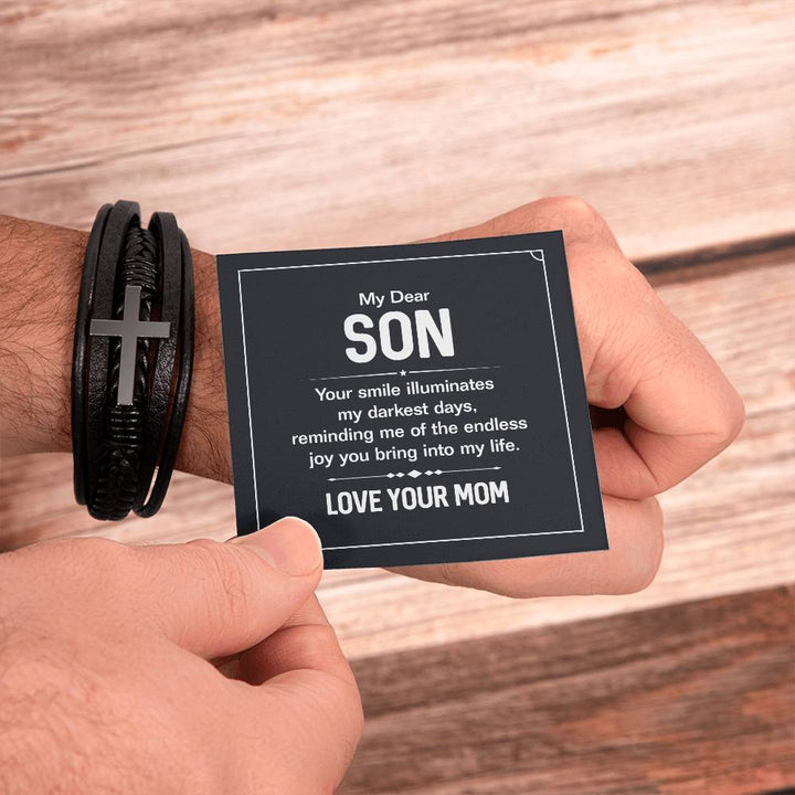 To My Dear Son | Your smile illuminates' my darkest shades - Men's Cross Leather Bracelet