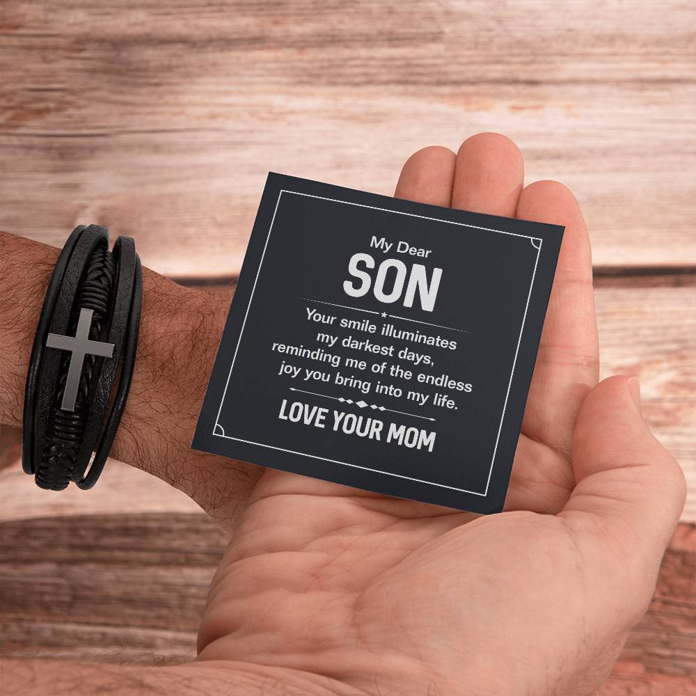 To My Dear Son | Your smile illuminates' my darkest shades - Men's Cross Leather Bracelet